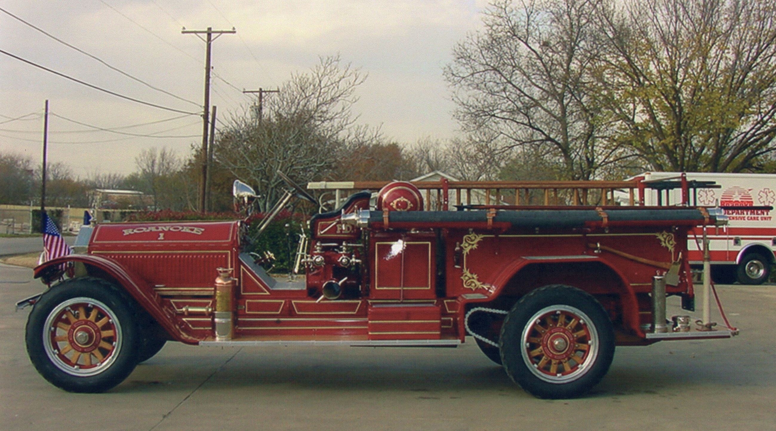 1923 red fire engine in front of buildings